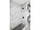 Walk-in shower with beautiful tiling, black fixtures and a comfortable bench at 320 Eaton St, Maitland, FL 32751