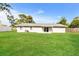 Backyard with green lawn, partial fence, and view of the home's exterior at 3312 Victory Palm Dr, Edgewater, FL 32141