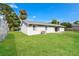 Well-maintained backyard with green lawn, partial fence, and view of the home's exterior at 3312 Victory Palm Dr, Edgewater, FL 32141