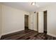Bedroom with wood-look flooring, closet, and a doorway leading to another room at 3312 Victory Palm Dr, Edgewater, FL 32141