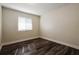 Bedroom with wood-look flooring, white trim, and a window providing natural light at 3312 Victory Palm Dr, Edgewater, FL 32141