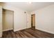 Bedroom with wood-look flooring, closet, and a doorway leading to another room at 3312 Victory Palm Dr, Edgewater, FL 32141