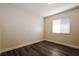 Neutral bedroom with wood-look flooring, white trim, and a window providing natural light at 3312 Victory Palm Dr, Edgewater, FL 32141