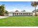 Charming single-story home with a well-manicured lawn and attached one car garage at 3312 Victory Palm Dr, Edgewater, FL 32141