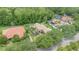 Aerial view showcases the property with its well-manicured lawn, tall trees, and proximity to the road at 336 Highcroft Ct, Lake Mary, FL 32746