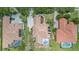 Aerial view of home with a large tile roof, screened-in pool, driveway and manicured landscaping at 336 Highcroft Ct, Lake Mary, FL 32746
