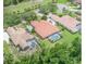 Aerial view of home with tile roof, screened-in pool, green lawn, and mature trees at 336 Highcroft Ct, Lake Mary, FL 32746