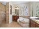 Luxurious bathroom featuring a soaking tub, granite countertops, and a separate shower at 336 Highcroft Ct, Lake Mary, FL 32746