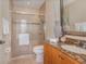 Well-lit bathroom with tiled shower, granite countertop vanity, and decorative mirror at 336 Highcroft Ct, Lake Mary, FL 32746
