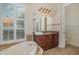 Beautiful bathroom showcasing a soaking tub, large window with plantation shutters, and granite vanity at 336 Highcroft Ct, Lake Mary, FL 32746