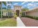 Beautiful home exterior with lush landscaping, palm trees, and inviting front entry at 336 Highcroft Ct, Lake Mary, FL 32746