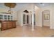 Open foyer featuring tile flooring, arched doorways, and elegant bar area at 336 Highcroft Ct, Lake Mary, FL 32746