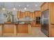 Well-lit kitchen with stainless steel appliances, wood cabinets, granite countertops, and a large center island at 336 Highcroft Ct, Lake Mary, FL 32746