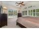 Bright main bedroom featuring a ceiling fan, large windows overlooking the pool and a wooden dresser at 336 Highcroft Ct, Lake Mary, FL 32746