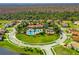 Beautiful aerial view of a community pool, clubhouse, and playground surrounded by lush landscaping and well-maintained homes at 3640 Sail Harbor Dr, Kissimmee, FL 34746