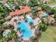 Stunning aerial view of a community pool and clubhouse with palm trees and lounge chairs around a sparkling pool at 3640 Sail Harbor Dr, Kissimmee, FL 34746