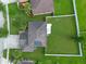 Aerial view showcasing a house with a fenced backyard, green lawn, and surrounding neighborhood landscape at 3640 Sail Harbor Dr, Kissimmee, FL 34746