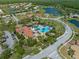 Wide aerial view of a neighborhood showcasing homes near a community center with a pool, playground, and lake at 3640 Sail Harbor Dr, Kissimmee, FL 34746