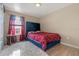 Cozy bedroom with a plush rug, upholstered headboard, and elegant red curtains at 3640 Sail Harbor Dr, Kissimmee, FL 34746