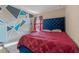 Stylish bedroom featuring a patterned wall, plush rug, and red curtains at 3640 Sail Harbor Dr, Kissimmee, FL 34746