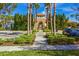 Elegant clubhouse exterior framed by palm trees and lush landscaping at 3640 Sail Harbor Dr, Kissimmee, FL 34746
