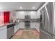 Modern kitchen featuring stainless steel appliances, granite countertops, and white cabinets at 3640 Sail Harbor Dr, Kissimmee, FL 34746