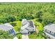 Aerial view of home with solar panels, landscaped yard, and mature trees at 3706 Andover Cay Blvd, Orlando, FL 32825