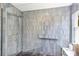 Gorgeous renovated shower with grey tile and brass rain shower head at 3706 Andover Cay Blvd, Orlando, FL 32825
