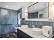 Bathroom features a double sink vanity, a sleek mirror, and modern blue tiling at 3706 Andover Cay Blvd, Orlando, FL 32825