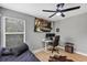 Relaxing bedroom with a daybed, desk, ceiling fan, and views from a large window at 3706 Andover Cay Blvd, Orlando, FL 32825