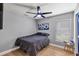 This cozy bedroom has a ceiling fan and an abundance of natural light at 3706 Andover Cay Blvd, Orlando, FL 32825