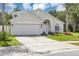 Charming single-story home boasts a well-manicured lawn, spacious driveway, and inviting front entrance at 3706 Andover Cay Blvd, Orlando, FL 32825