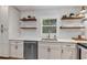 Modern kitchen with white cabinets, stainless steel appliances, and open shelving at 3706 Andover Cay Blvd, Orlando, FL 32825
