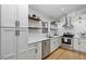 Bright kitchen features white cabinets, stainless steel appliances, and floating shelves at 3706 Andover Cay Blvd, Orlando, FL 32825