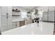 Modern kitchen featuring white cabinets, stainless steel appliances, and a large island with white countertops at 3706 Andover Cay Blvd, Orlando, FL 32825