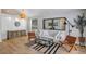 Bright living room with modern decor, featuring hardwood floors, stylish furniture, and a decorative brick accent wall at 3706 Andover Cay Blvd, Orlando, FL 32825