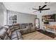 Inviting living room featuring a comfy gray sectional, natural light, and entertainment center at 3706 Andover Cay Blvd, Orlando, FL 32825