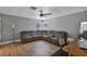 Spacious living room with new flooring, ceiling fan, and oversized gray leather sectional sofa at 3706 Andover Cay Blvd, Orlando, FL 32825