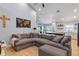 Open-concept living room with a large, plush sectional couch and views into the kitchen at 3706 Andover Cay Blvd, Orlando, FL 32825