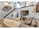 Contemporary living area with a cozy sectional sofa, fireplace, and staircase with glass railing at 3706 Andover Cay Blvd, Orlando, FL 32825