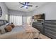 Light filled bedroom featuring an ensuite bath, ceiling fan, and wood look flooring at 3706 Andover Cay Blvd, Orlando, FL 32825