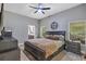 Spacious bedroom with ensuite bathroom, ceiling fan, and plenty of natural light at 3706 Andover Cay Blvd, Orlando, FL 32825