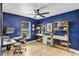 Bright office space with blue accent wall, ceiling fan, built-in shelves, and natural light at 3706 Andover Cay Blvd, Orlando, FL 32825