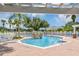 Community pool with waterfall feature and lounge chairs at 3706 Andover Cay Blvd, Orlando, FL 32825