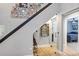 Modern staircase with glass railings, decorative artwork, and views into other rooms at 3706 Andover Cay Blvd, Orlando, FL 32825