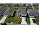 Aerial view of a two-story home with a landscaped front yard and a driveway with a parked car at 3823 Spruce Creek Dr, Lakeland, FL 33811