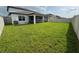 Well-maintained fenced backyard with screened lanai and lush green grass at 3823 Spruce Creek Dr, Lakeland, FL 33811