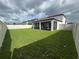 Landscaped backyard features a screened-in lanai and a well-maintained lawn at 3823 Spruce Creek Dr, Lakeland, FL 33811