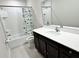 Clean bathroom featuring a tub and shower combo, with a modern vanity and bright lighting at 3823 Spruce Creek Dr, Lakeland, FL 33811
