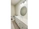 Bathroom featuring an oval mirror, white cabinets, and modern fixtures at 3823 Spruce Creek Dr, Lakeland, FL 33811